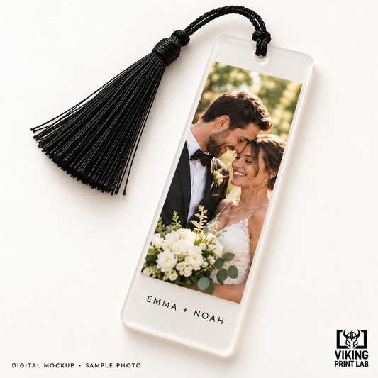 Digital mockup of a personalized frosted acrylic wedding photo bookmark with a black tassel.