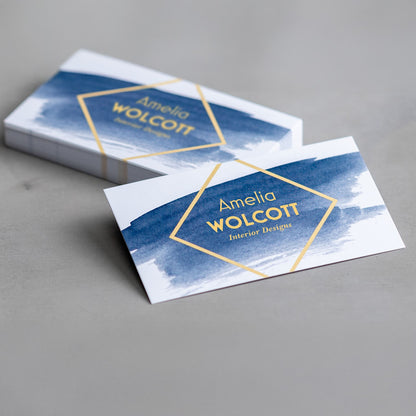 Sample square-corner matte business cards with a blue interior design layout.