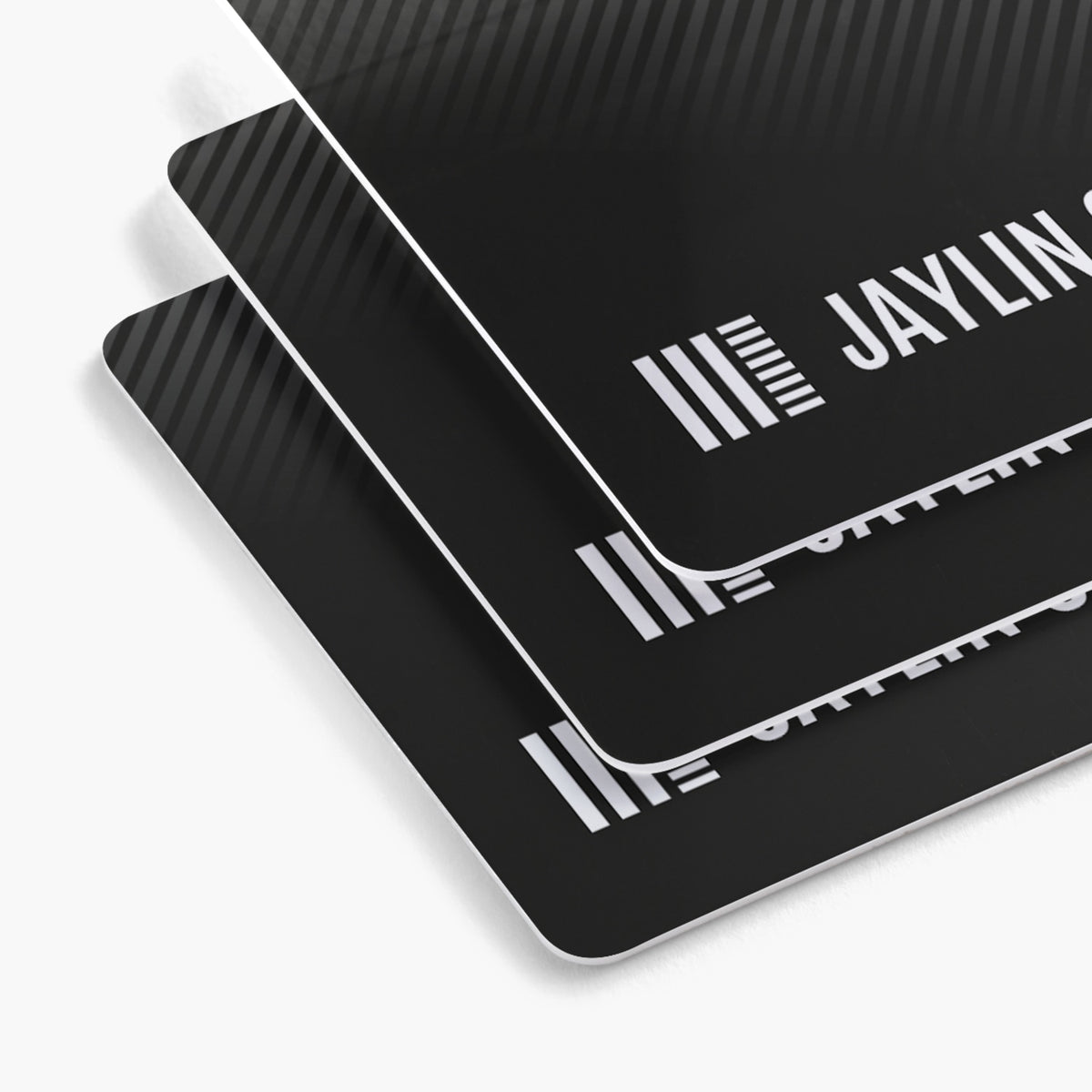 Rounded white plastic business card examples with black printed designs.