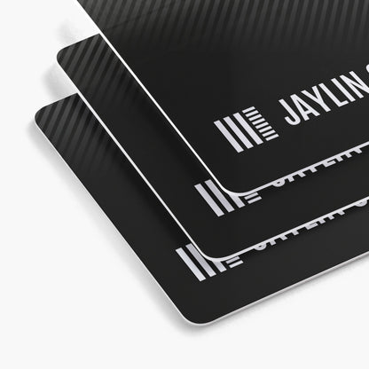 Rounded white plastic business card examples with black printed designs.