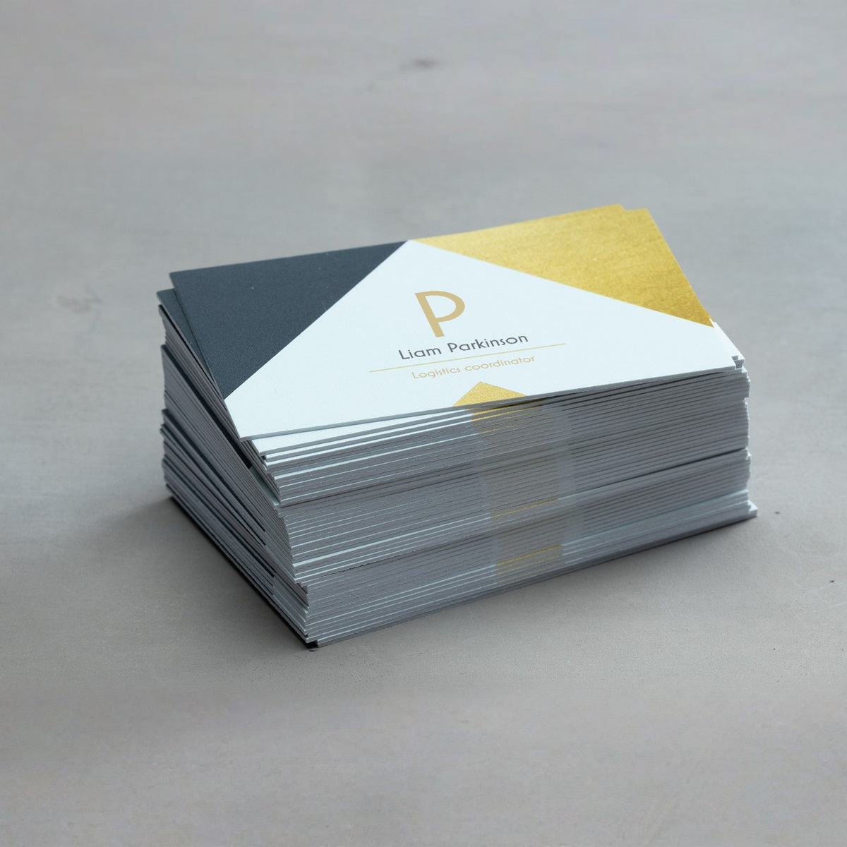 Ultra-thick business cards stacked with an example geometric design.