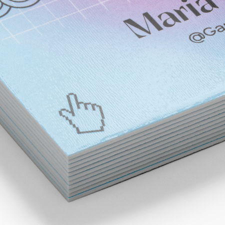 Close-up of 32pt ultra-thick business card paper showing the substantial card edge and an example printed design.