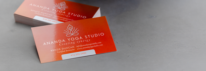 Orange Ananda Yoga Studio business cards showing a glossy finish; thickness depends on selected option.