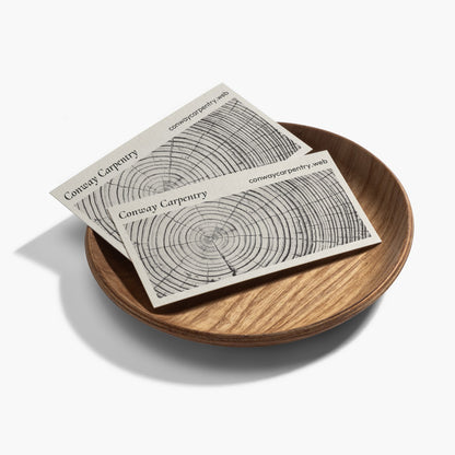 Bamboo paper business cards displayed on a wooden dish