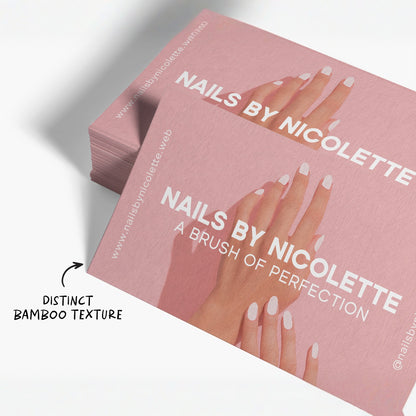 Close view of bamboo paper business cards with salon sample artwork