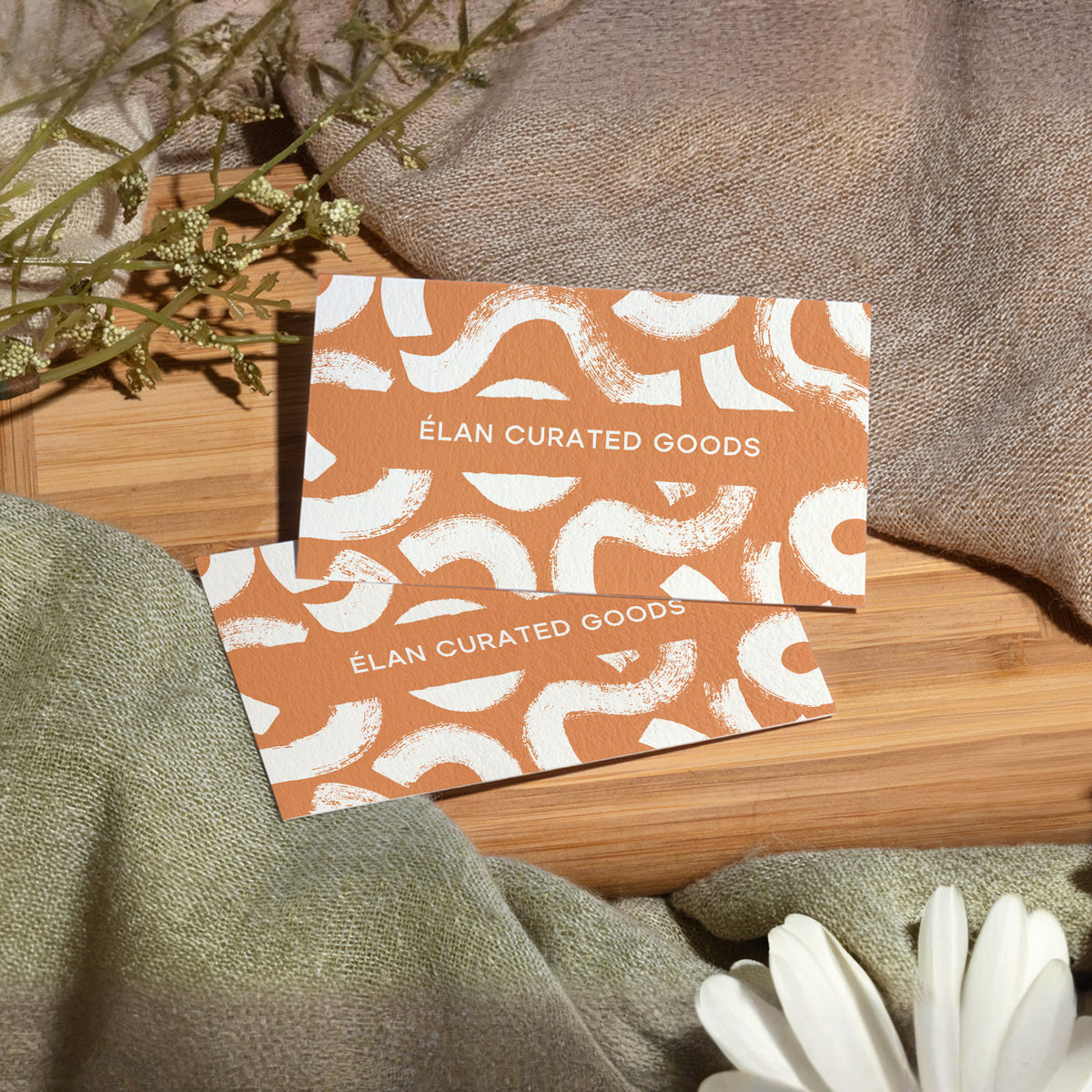 Example cotton business cards with an orange and white custom design.