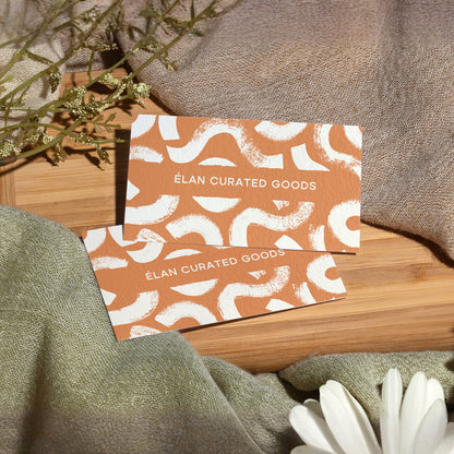 Example cotton business cards with an orange and white custom design.