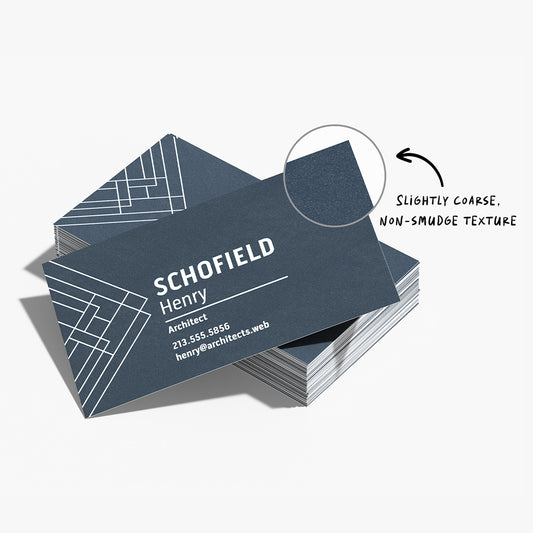 Fine grit business cards with a close view of the textured surface