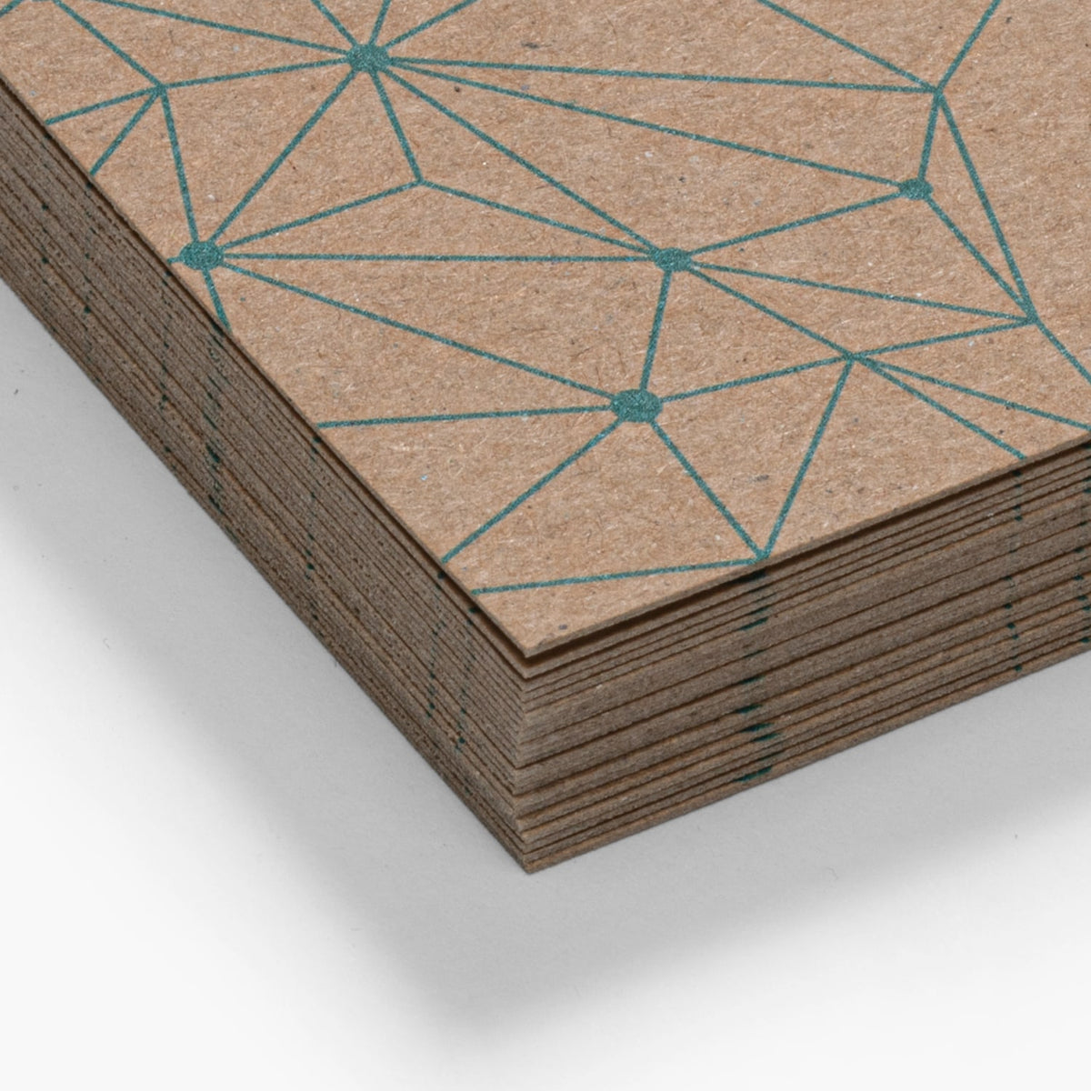 Close-up of geometric artwork printed on kraft card stock.