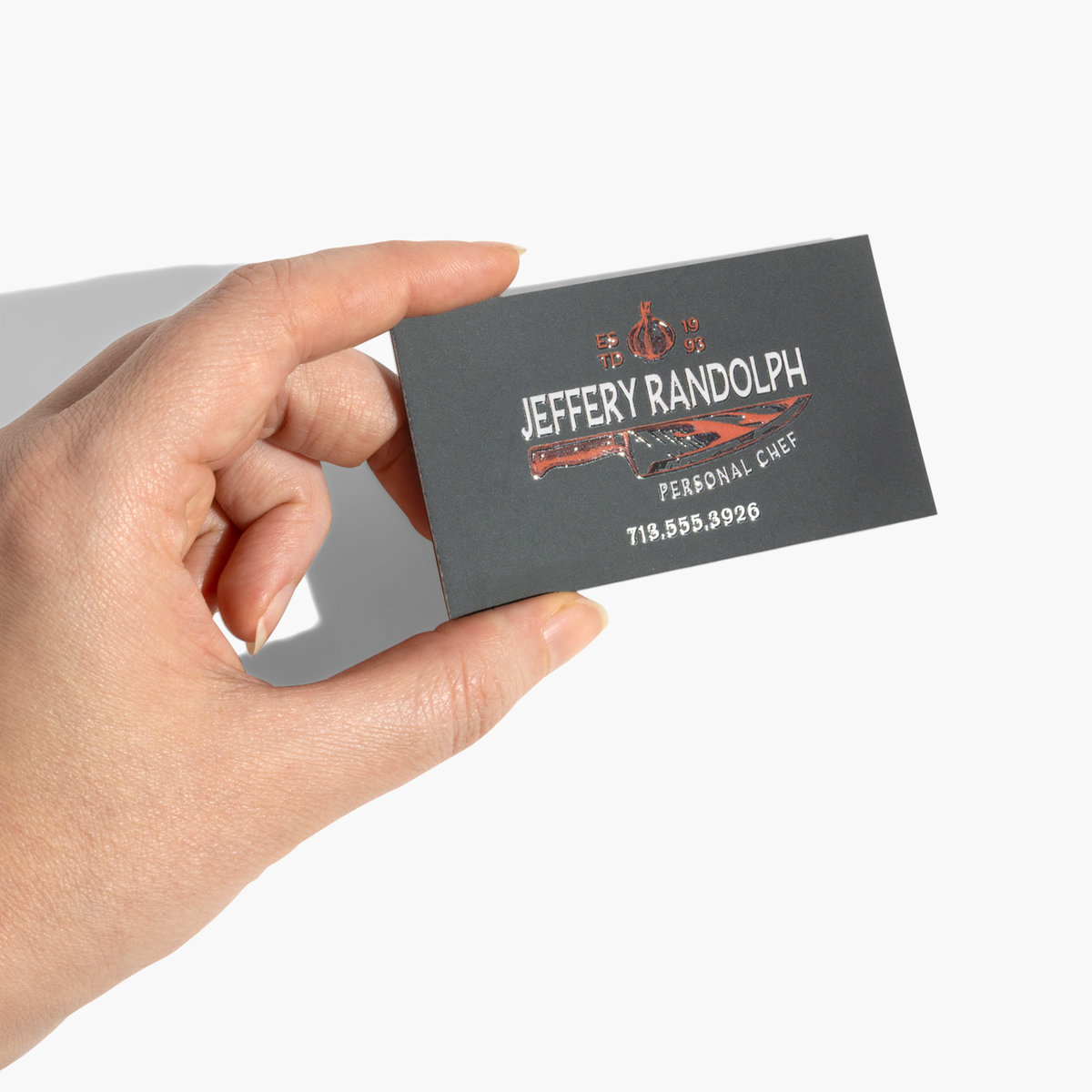 Magnetic business card held in one hand