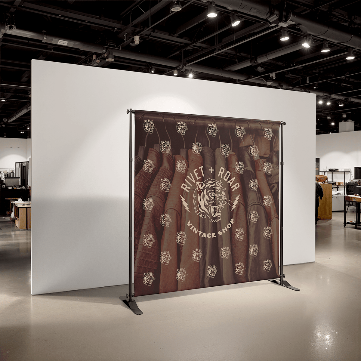 Assembled custom step-and-repeat backdrop with sample shop artwork