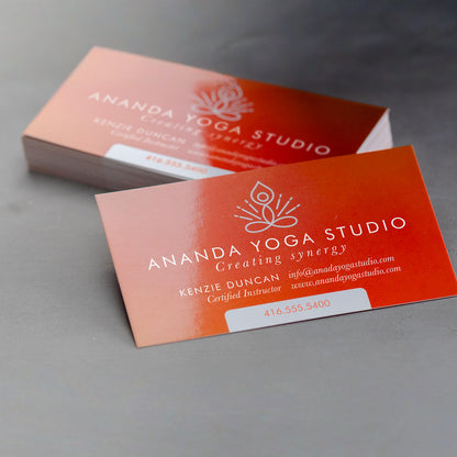 Example glossy business cards with a coral yoga studio design.