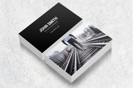 Sample laminated business cards showing a photography design on both sides.