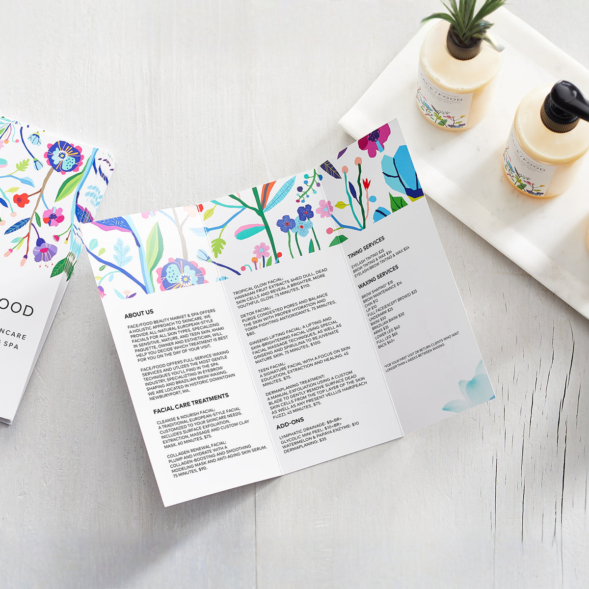 Example open trifold brochure showing three interior panels and a floral design.